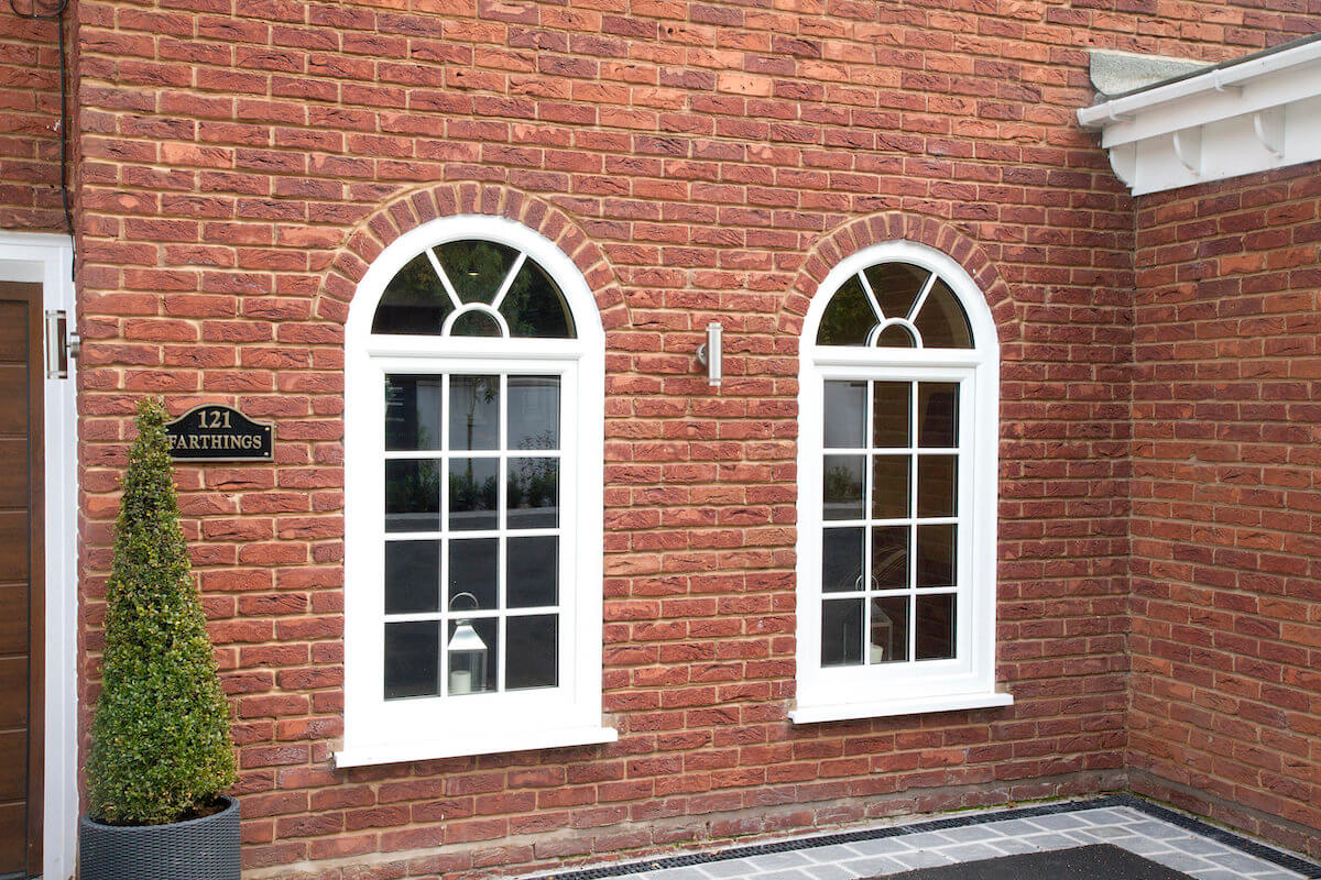 white upvc arched tilt and turn window