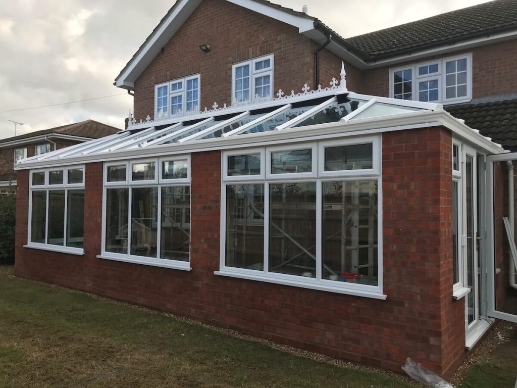 red brick orangery with white upvc