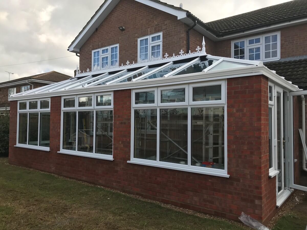 red brick orangery with white upvc