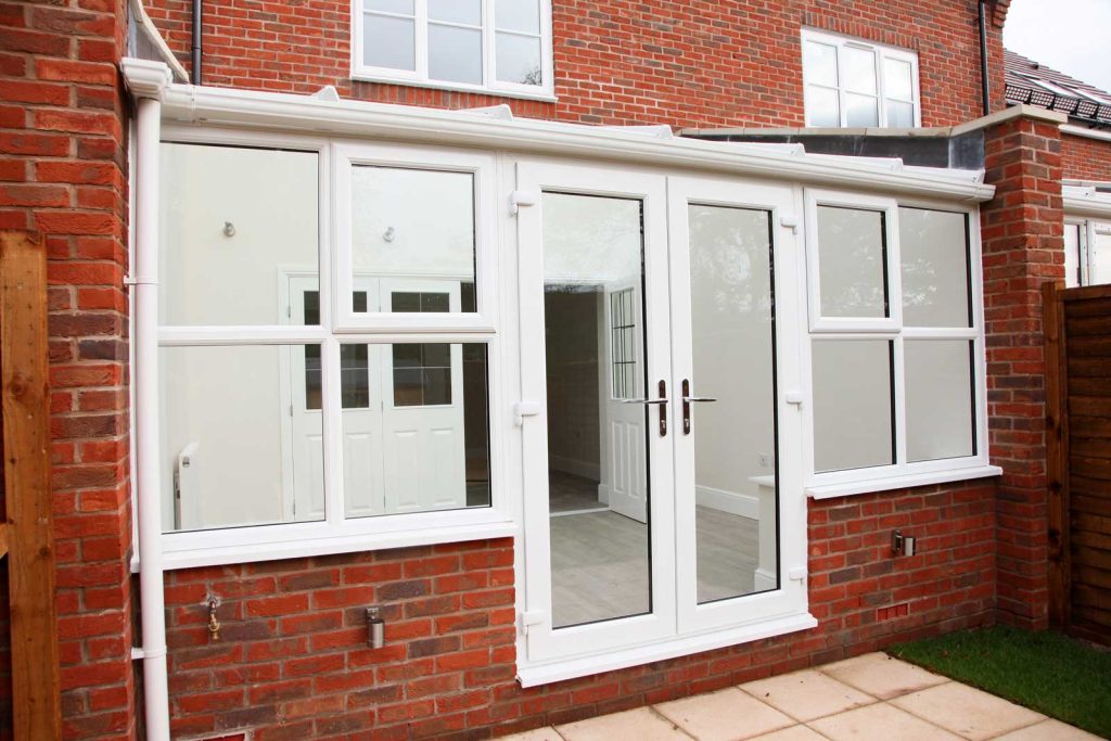 white upvc french doors in conservatory