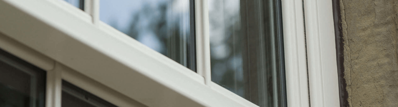 Close-up of a white casement window frame with high-performance glazing.