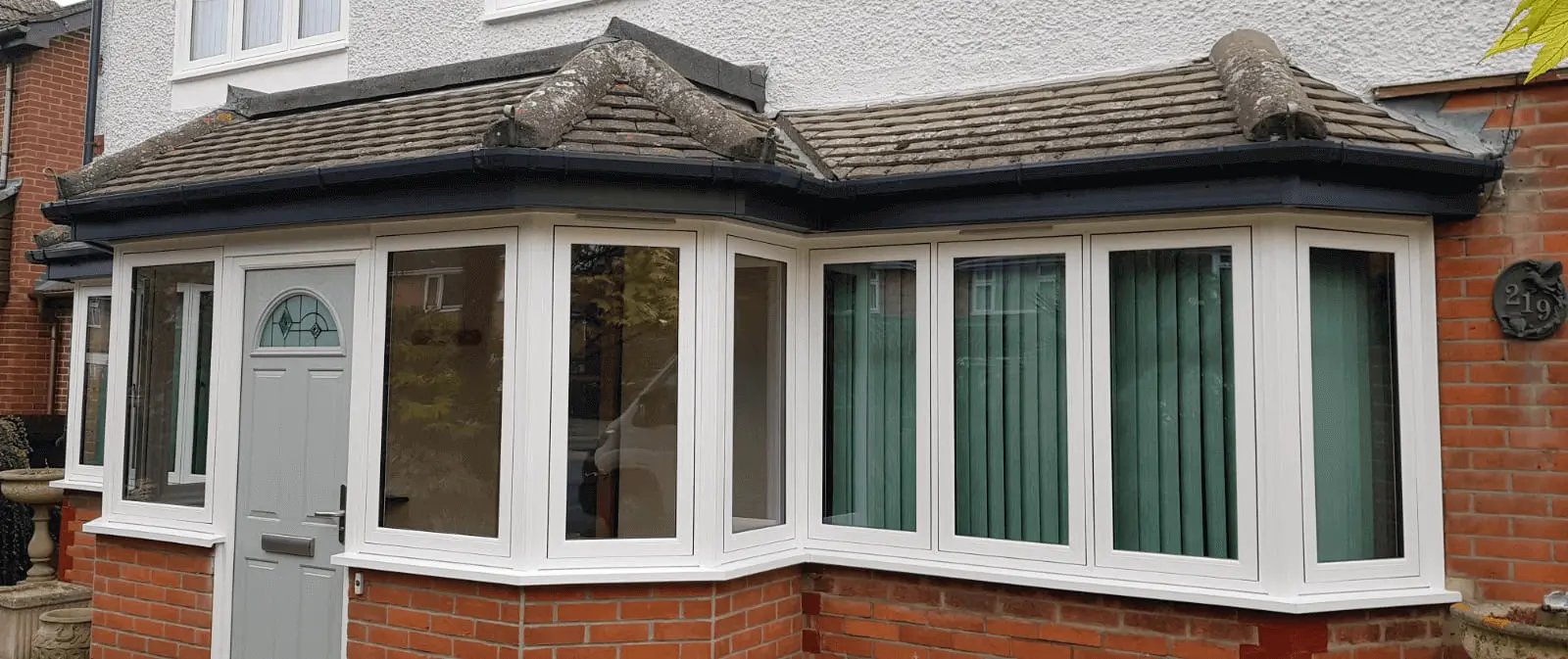 white upvc flush sash windows and grey entrance door